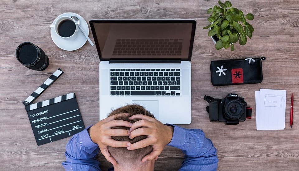 A frustrated man working at a computer